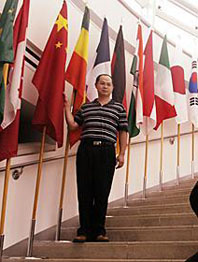  Huiyu Zheng of the Chinese delegation visiting Pittsburgh for the G20 Summit, poses with the Chinese flag on the steps of the welcome center at Phipps Conservatory and Botanical Gardens, September 23. Doug Oster/Post-Gazette.