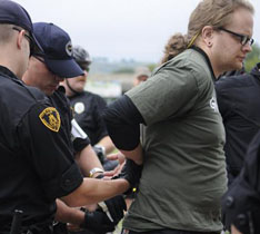 Protesting the G20 in Pittsburgh: One of five Greenpeace activists is handcuffed in Point State Park after being arrested for attempting to hang a banner off the Fort Pitt Bridge, September 23.. Pam Panchak / Post-Gazette. 