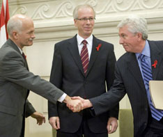 NDP Leader Jack Layton and Bloc leader Gilles Duceppe shake hands as then-Liberal leader Stephane Dion looks on after signing a coalition agreement on Dec. 1, 2008.