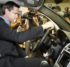 Ontario Premier Dalton McGuinty sits in a GM hydrogen fuel cell vehicle.