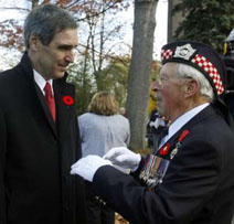 Liberal Leader Michael Ignatieff speaks with 87-year-old veteran Ernie Scale (R) before a wreath-laying ceremony during Remembrance Day services at the Long Branch Cenotaph in Toronto November 11, 2009. REUTERS/ Mike Cassese.