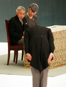 Emperor Akihito and Empress Michiko look on as Japanese Prime Minister Shinzo Abe bows towards them during the memorial service for the war dead of World War II at Nippon Budokan Hall, August 15, 2007, in Tokyo, Japan.