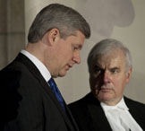 Prime Minister Stephen Harper speaks with Commons Speaker Peter Milliken during a signing ceremony for the Book of Reflection in Ottawa, March 29, 2010. ADRIAN WYLD/THE CANADIAN PRESS.