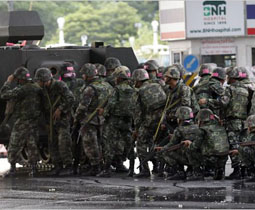 Thai soldiers assemble in front of a barricade made by protesters in Bangkok on Wednesday [May 19]. Ahmad Yusni/European Pressphoto Agency.