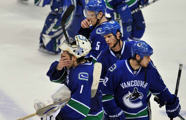 Vancouver Canucks defenceman Kevin Bieksa (second from right) has a consoling word for goalie Roberto Luongo as the Canucks await the post-series handshake after losing 5-1 to the visiting Chicago Blackhawks at GM Place on Tuesday, May 11, 2010.