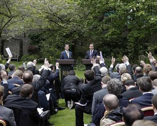 Prime Minister David Cameron (r) and Deputy Prime Minister Nick Clegg hold their first joint news conference in the garden of 10 Downing Street, 12 May 2010. REUTERS/Christopher Furlong/POOL.