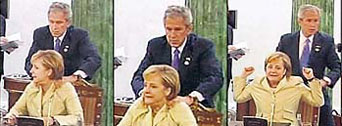 President George W. Bush giving impromptu neck massage to German Chancellor Angela Merkel at the G8 Summit in St. Petersburg, Russia, July 2006. Photos: ZDF, German Television.