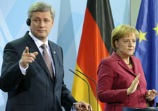 PM Harper and Chancellor Merkel speak at a news conference in Berlin, May 8, 2010. MICHAEL GOTTSCHALK/AFP/GETTY IMAGES.