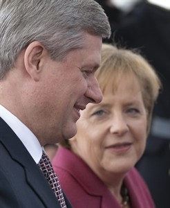 PM Harper speaks with Chancellor Merkel as he arrives at the Chancellery in Berlin, Germany Saturday, May 8, 2010. THE CANADIAN PRESS/Adrian Wyld.