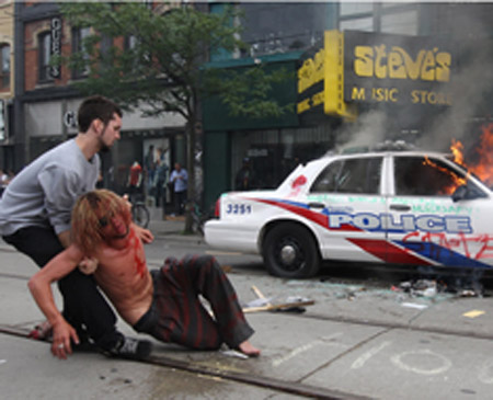 STEVE RUSSELL (photo): A high-minded democratic protester is overcome by smoke after attempting to put out a fire in a police car at Queen Street West near Spadina.