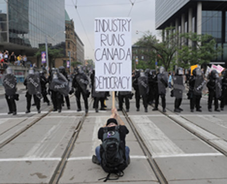 LUCAS OLENIUK (photo): The riot ended at Queen’s Park – just a bit north, to the right of this photo, which shows the intersection of College and University, looking west along College  – but little outbreaks continued across the downtown.