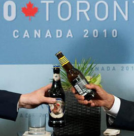 US President Barack Obama (r) and British Prime Minister David Cameron (l) clink bottles of beer as they settle a bet on the US-UK World Cup Soccer game, during meeting on sidelines of  G20 Summit in Toronto. SAUL LOEB/AFP/Getty Images.