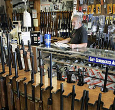 Ed Etheridge works behind a counter at Rink’s Gun and Sport in the Chicago suburb of Lockport, Ill. Frank Polich / Reuters. 